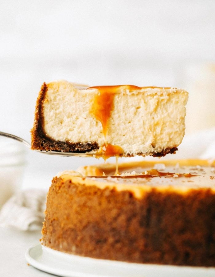 lifting out a slice of salted caramel cheescake