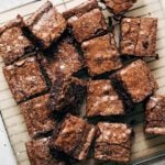 a tray of sliced brownies sprinkled with powdered sugar