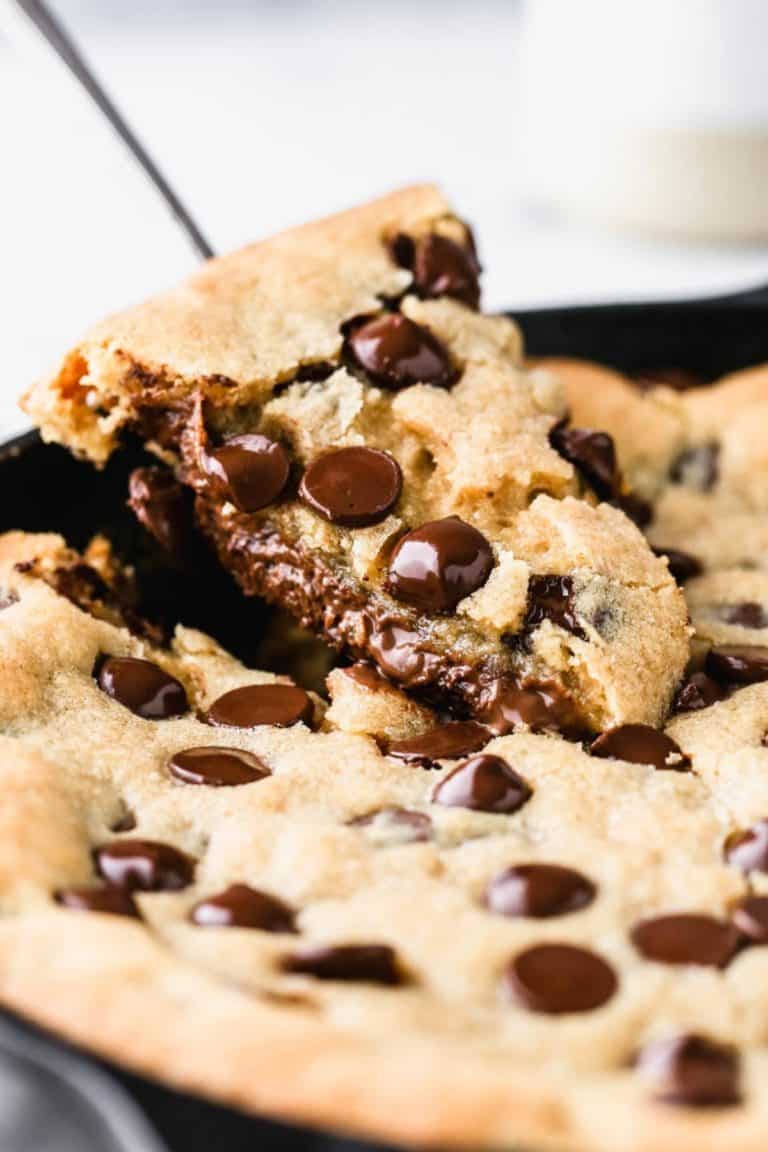 lifting a slice from a deep dish skillet cookie