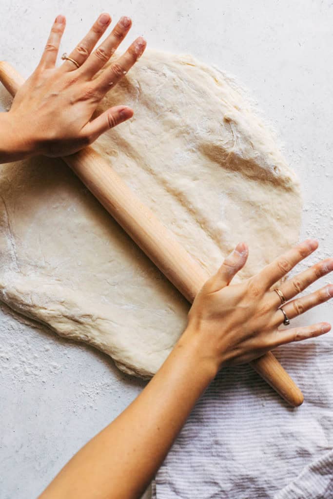 rolling out cinnamon roll dough