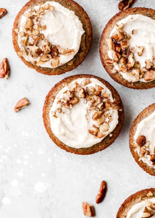 gluten free banana bread cheesecake cups with pecans sprinkled on top