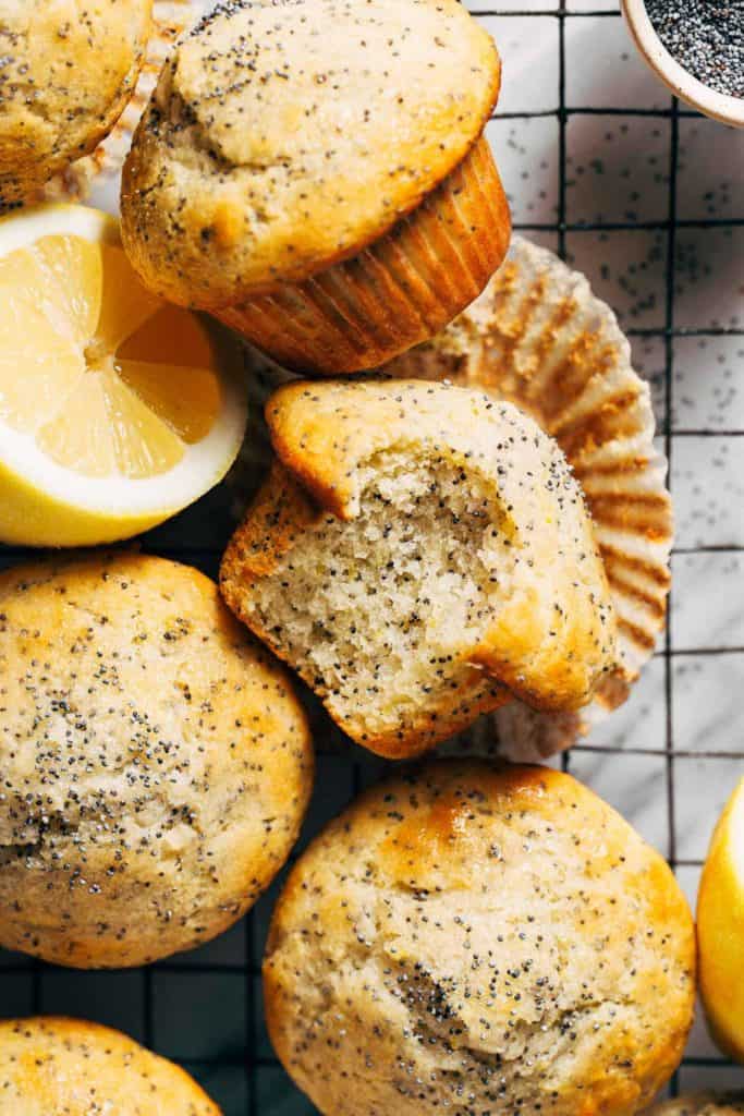 lemon poppy seed muffins scattered on a cooling rack