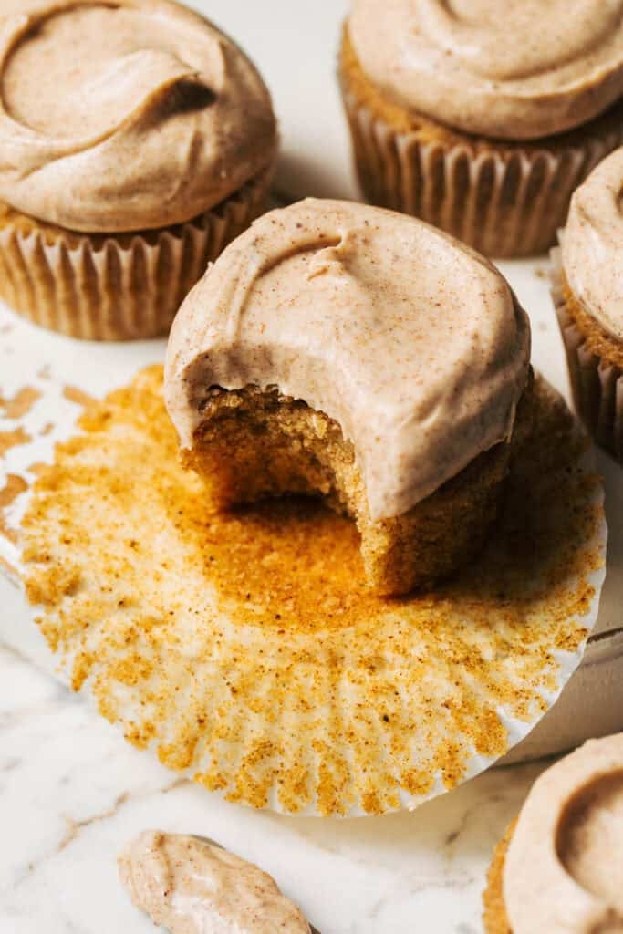 a bite taken from a brown butter cupcake