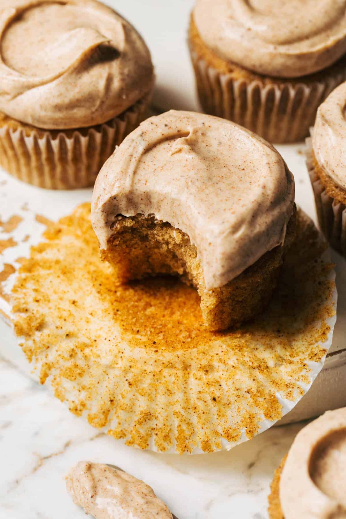 a bite taken from a brown butter cupcake