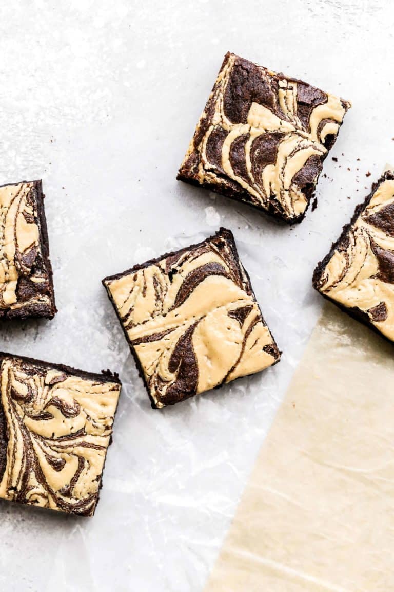 peanut butter swirl brownies scattered on parchment paper