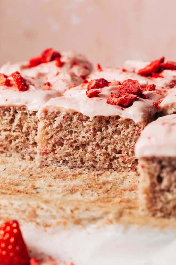 side view of a sliced strawberry sheet cake