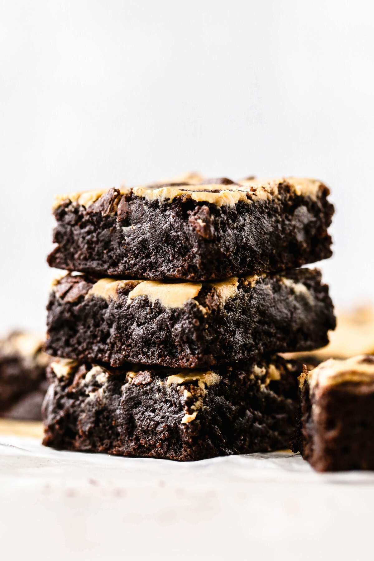 a stack of fudgy tahini and peanut butter swirl brownies