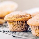 a gluten free pumpkin muffin on a wire cooling rack