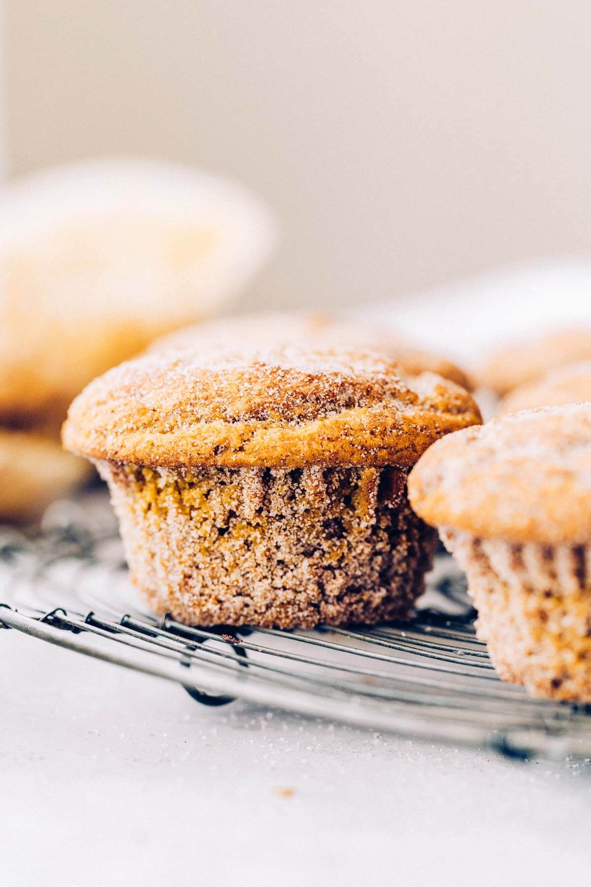 a gluten free pumpkin muffin on a wire cooling rack