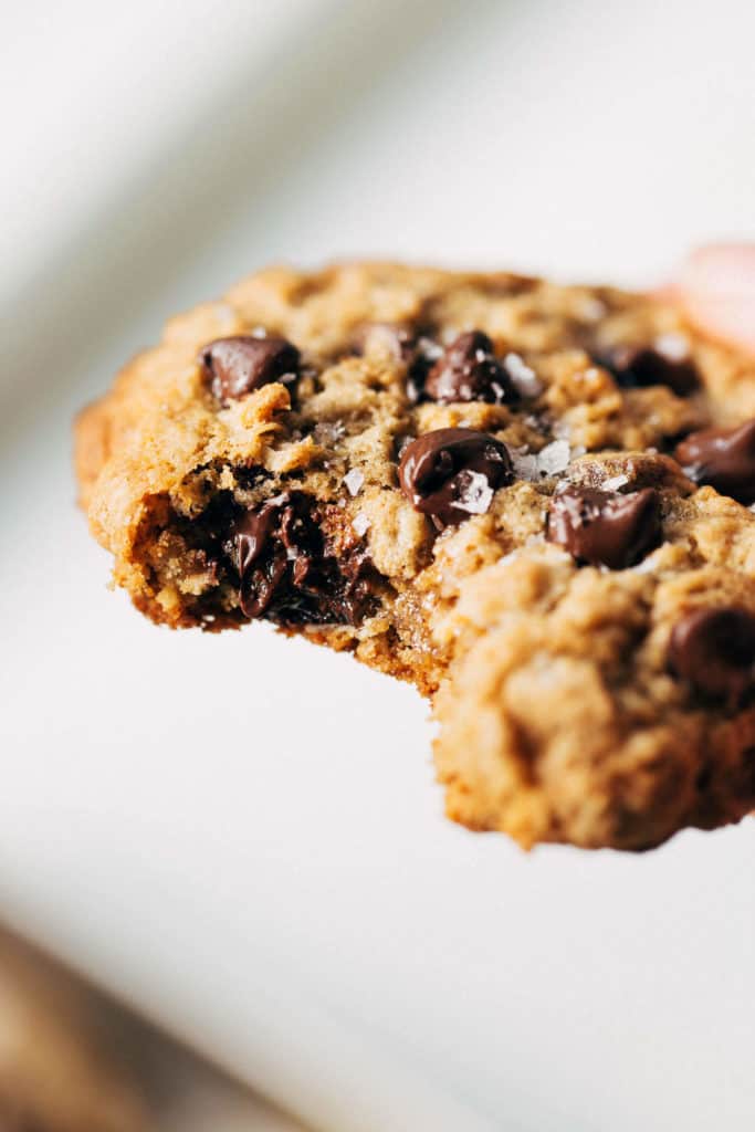 close up on a bite taken from a gluten free oatmeal chocolate chip cookie