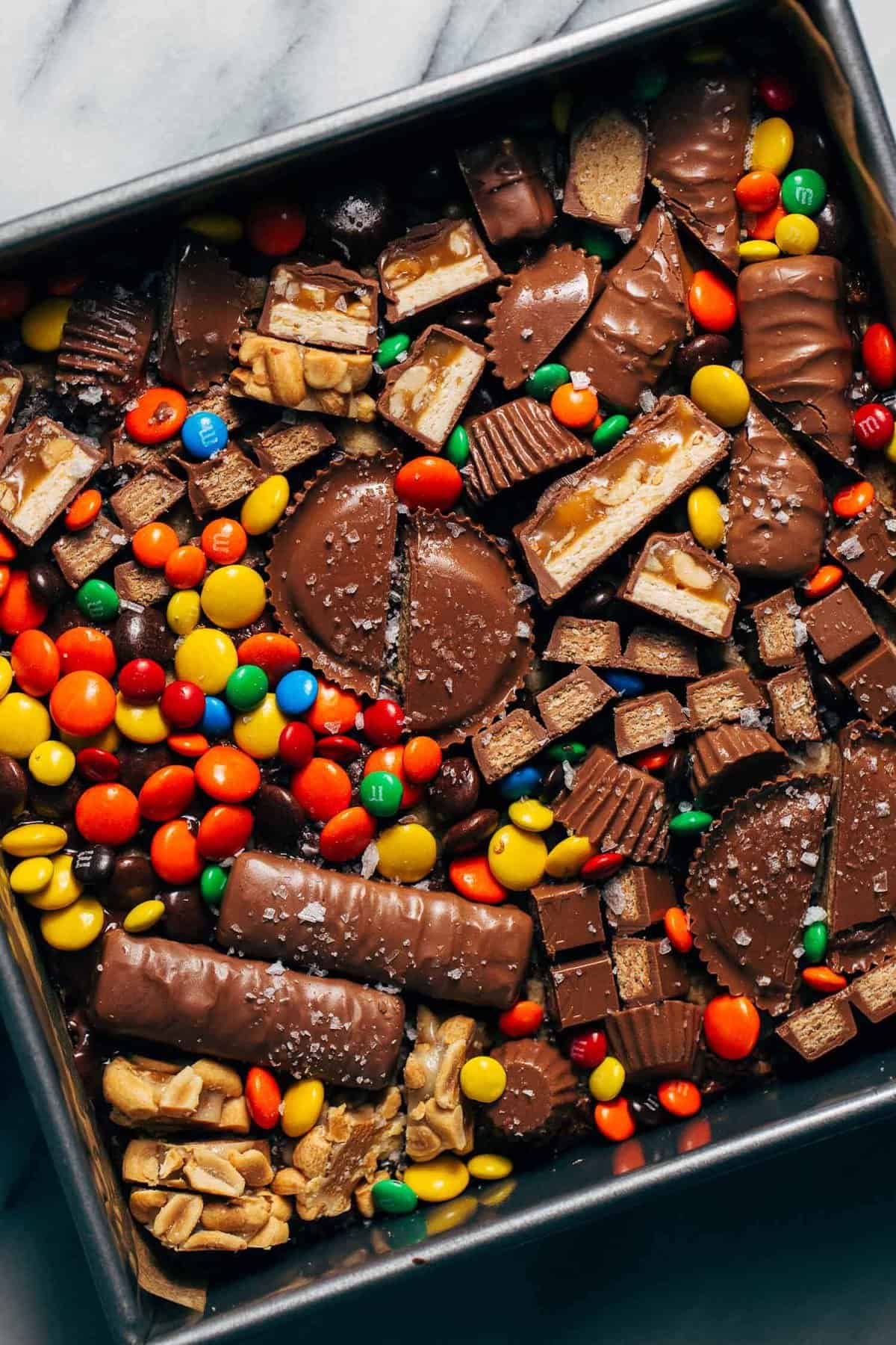 halloween candy loaded on top of cookie bars