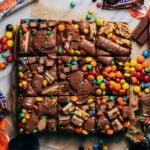 candy piled on top of sliced cookie bars