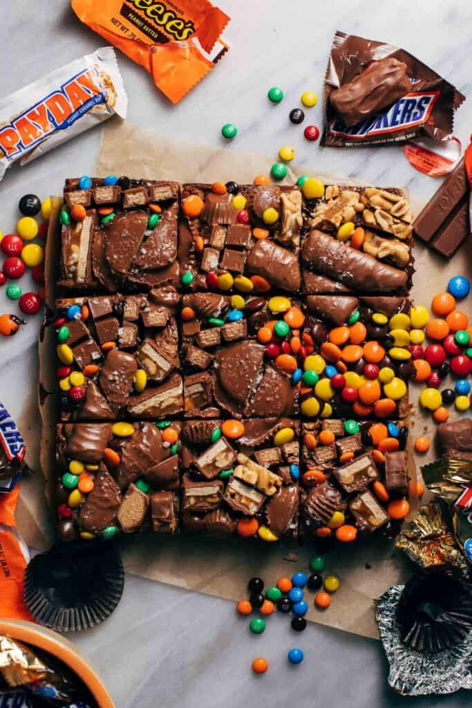 candy piled on top of sliced cookie bars