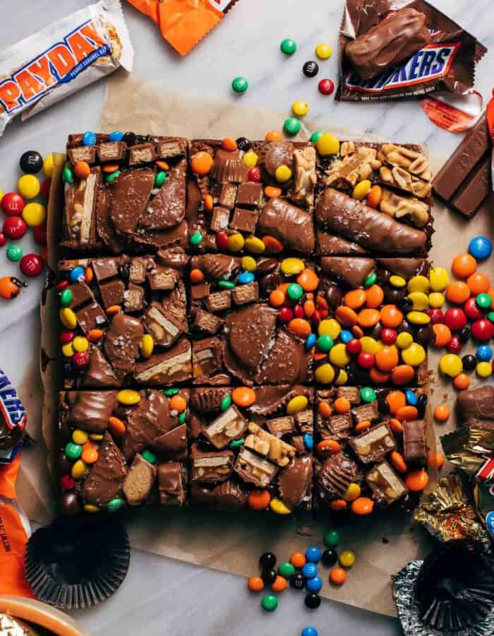 candy piled on top of sliced cookie bars
