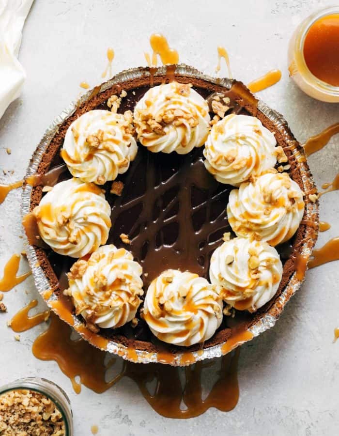 a complete turtle pie with caramel drizzled on top