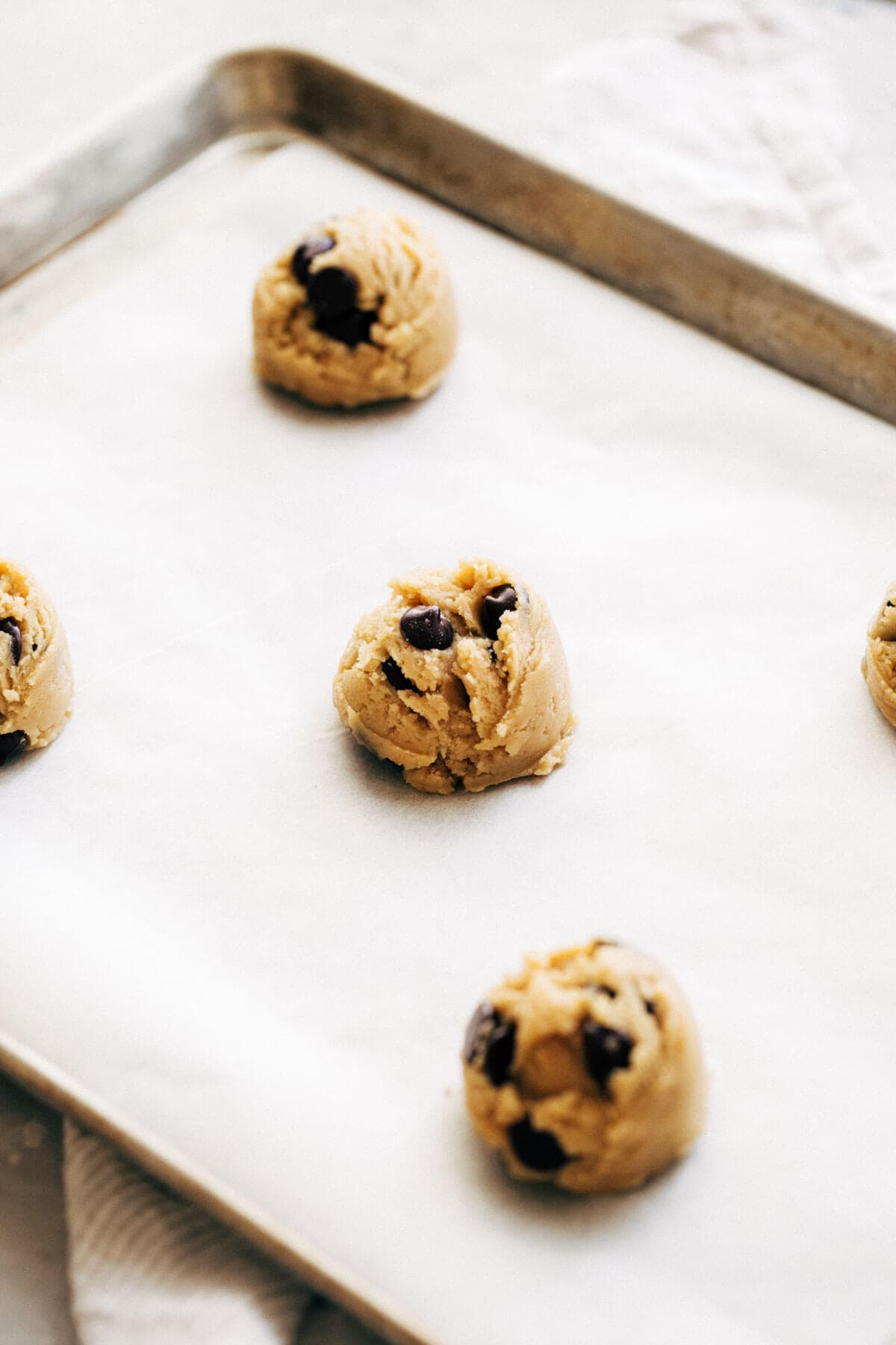 cookie dough scooped onto a baking sheet