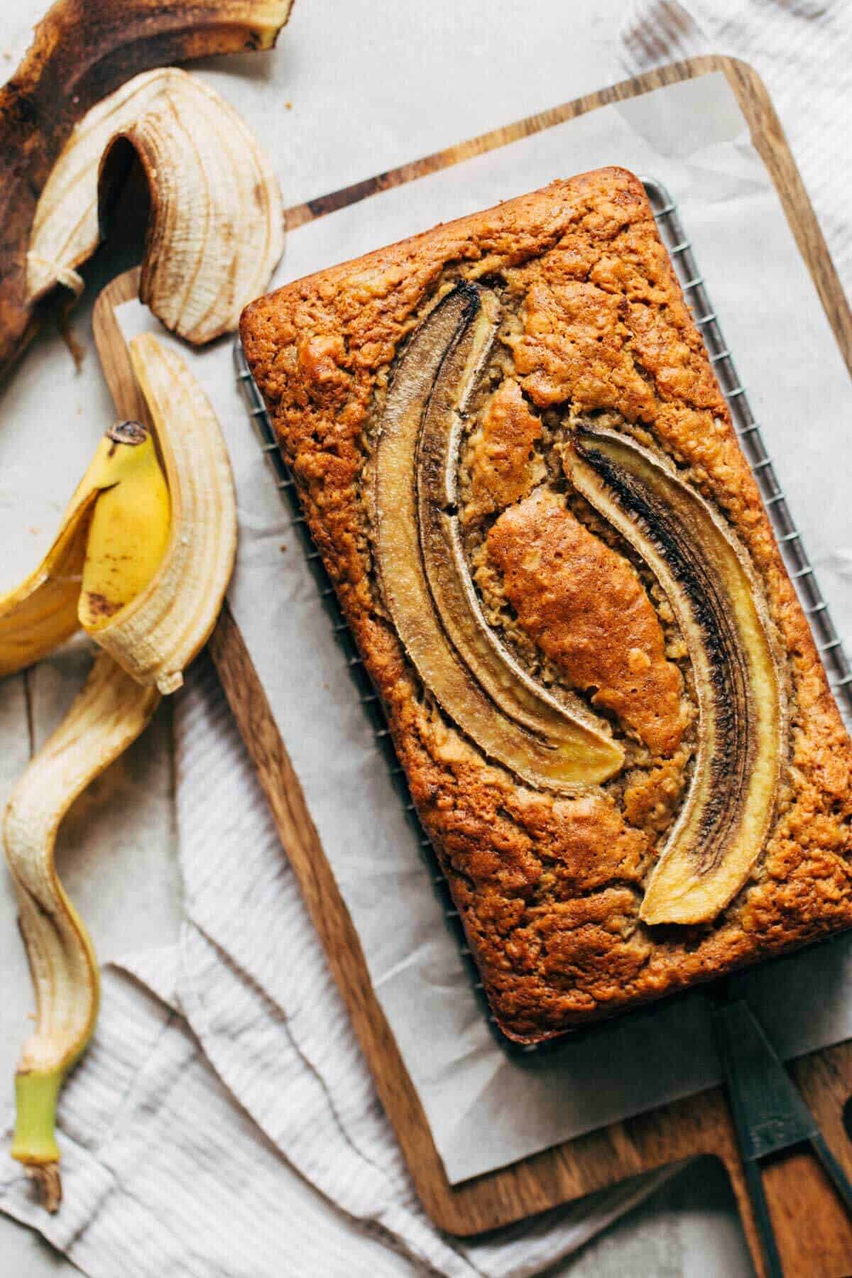 freshly baked banana bread with sliced bananas on top