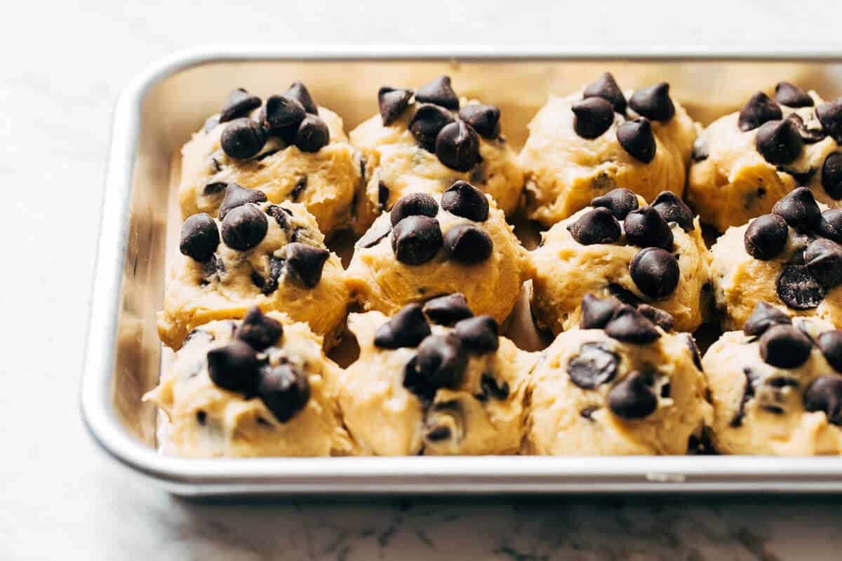 balls of soft chocolate chip cookie dough on a baking sheet