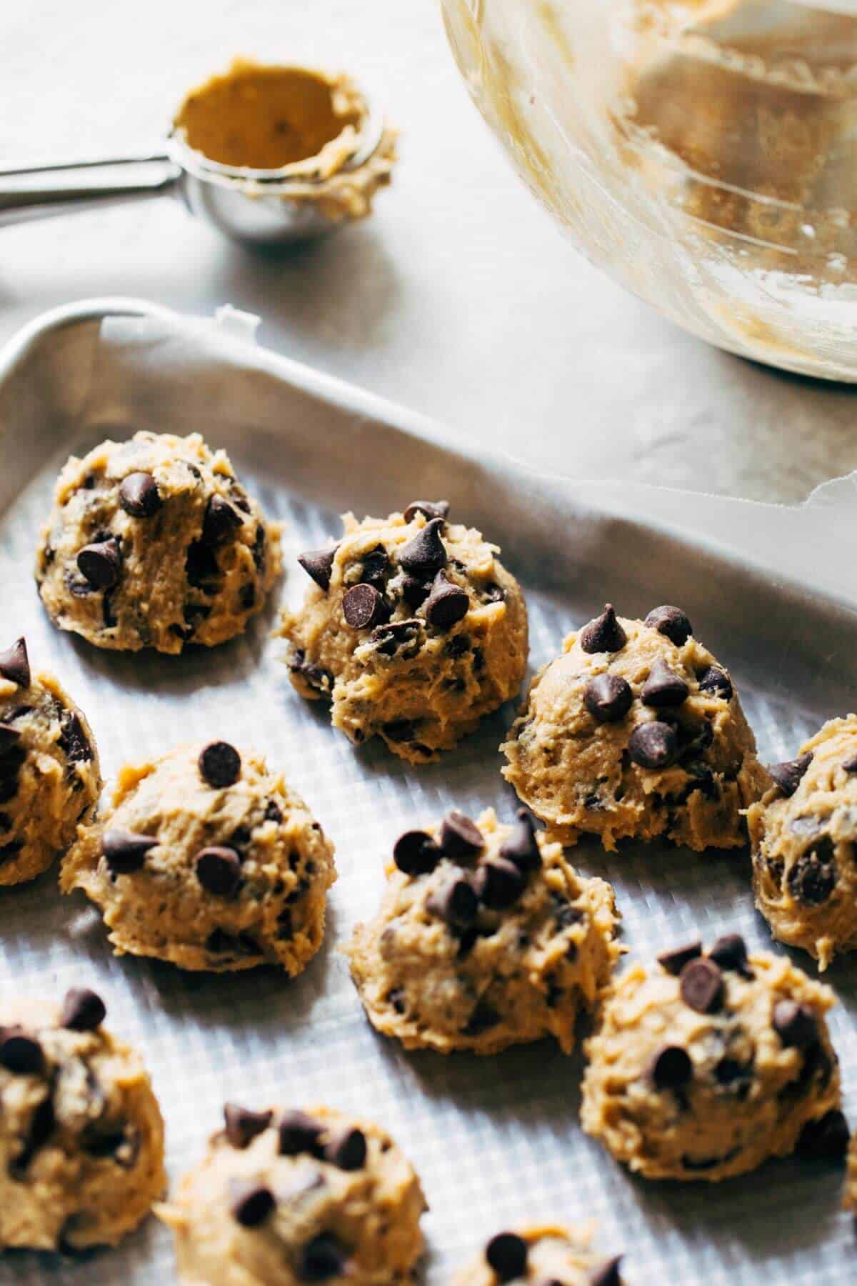 scooped cookie dough on a baking tray