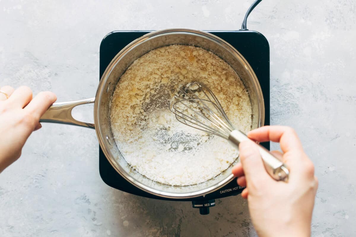 Sugar being whisked in a saucepan.