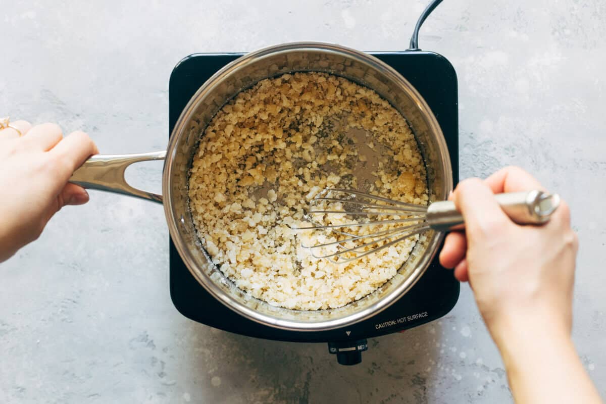 Whisking sugar in a saucepan