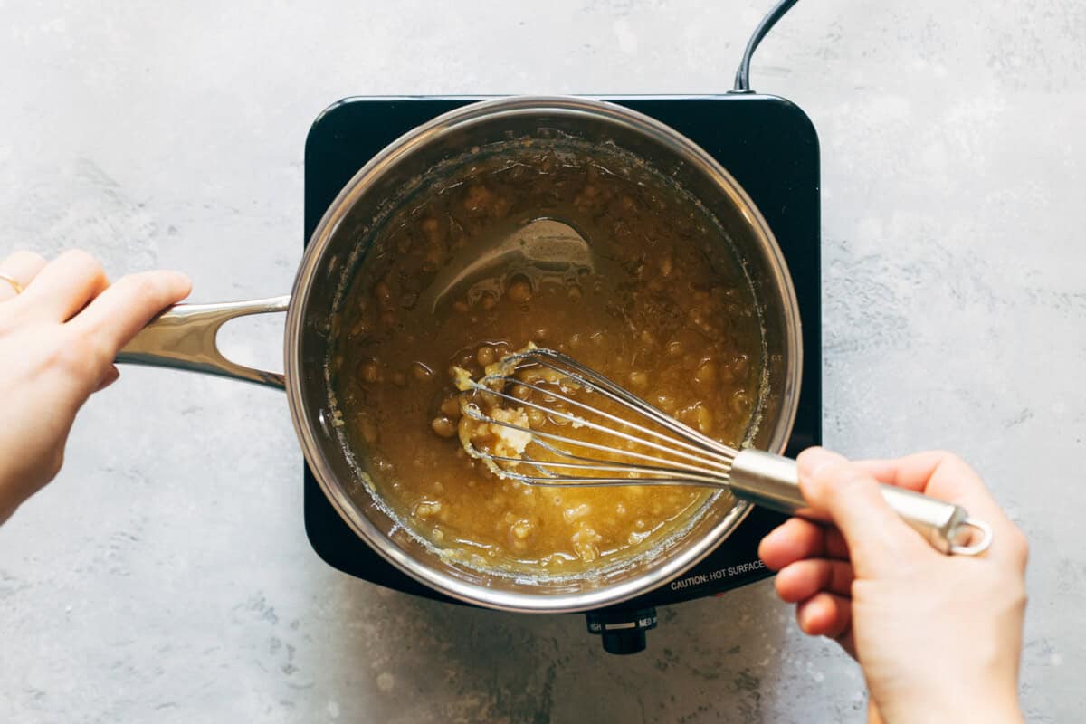 Whisking sugar to make homemade salted caramel.