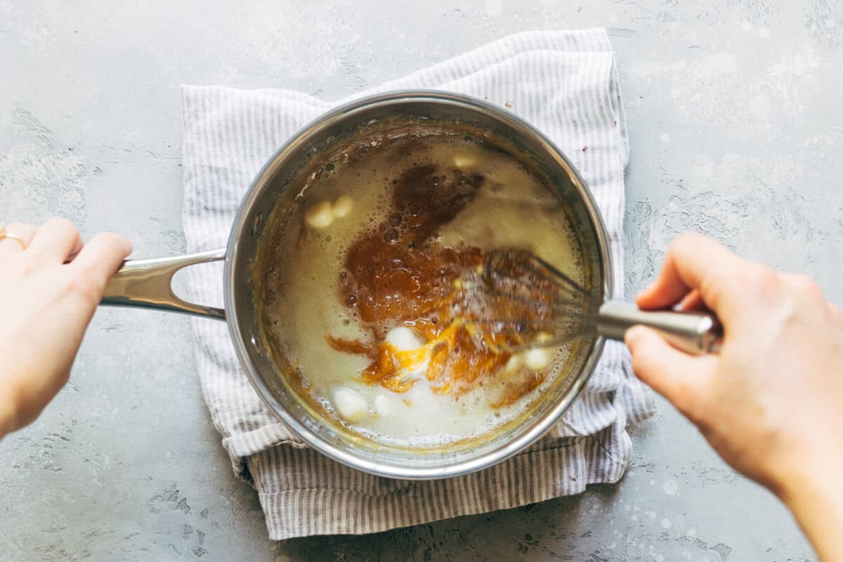 Whisking butter and cream into homemade salted caramel.