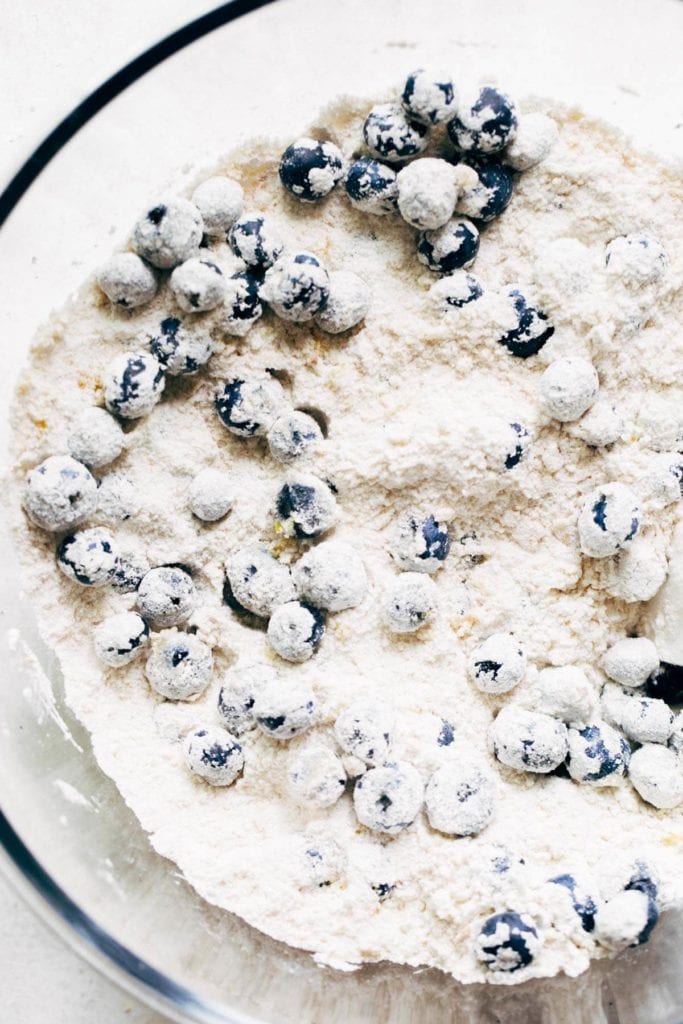a bowl of dry ingredients and blueberries
