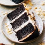 a slice of chocolate cake on a pottery plate