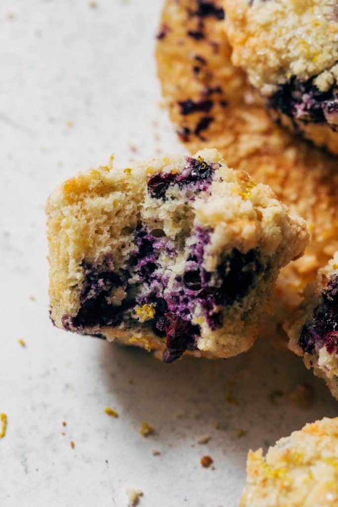 a lemon blueberry muffin with a bite taken out