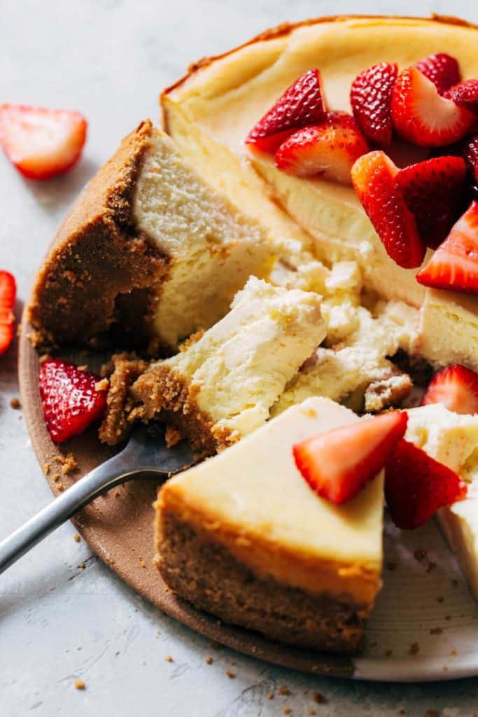 a fork dug into a whole cheesecake