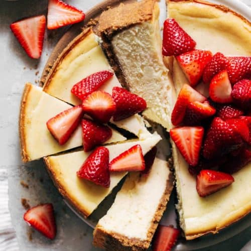 the top of a baked cheesecake topped with strawberries