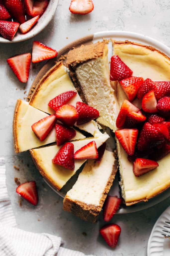 the top of a baked cheesecake topped with strawberries