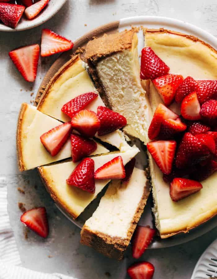 the top of a baked cheesecake topped with strawberries