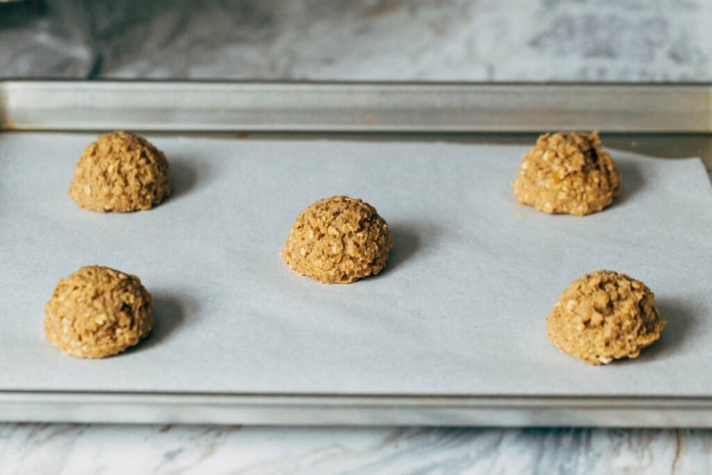 oatmeal cookie dough scooped onto a baking pan