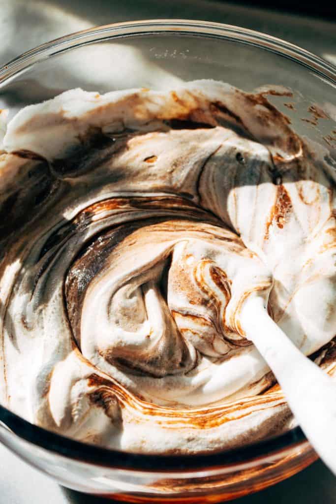 gently folding meringue into chocolate mixture