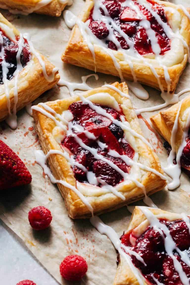 cream cheese danish with glazed berries on top and an icing drizzle