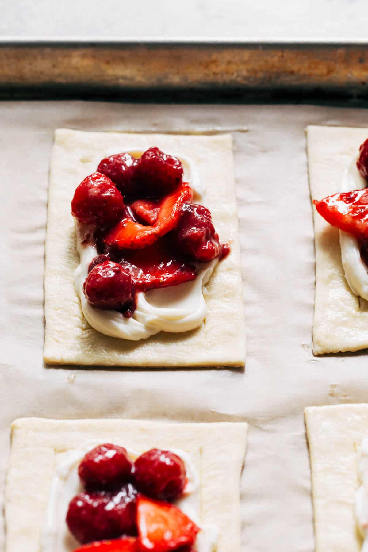 fresh berries on top of puff pastry, ready to bake