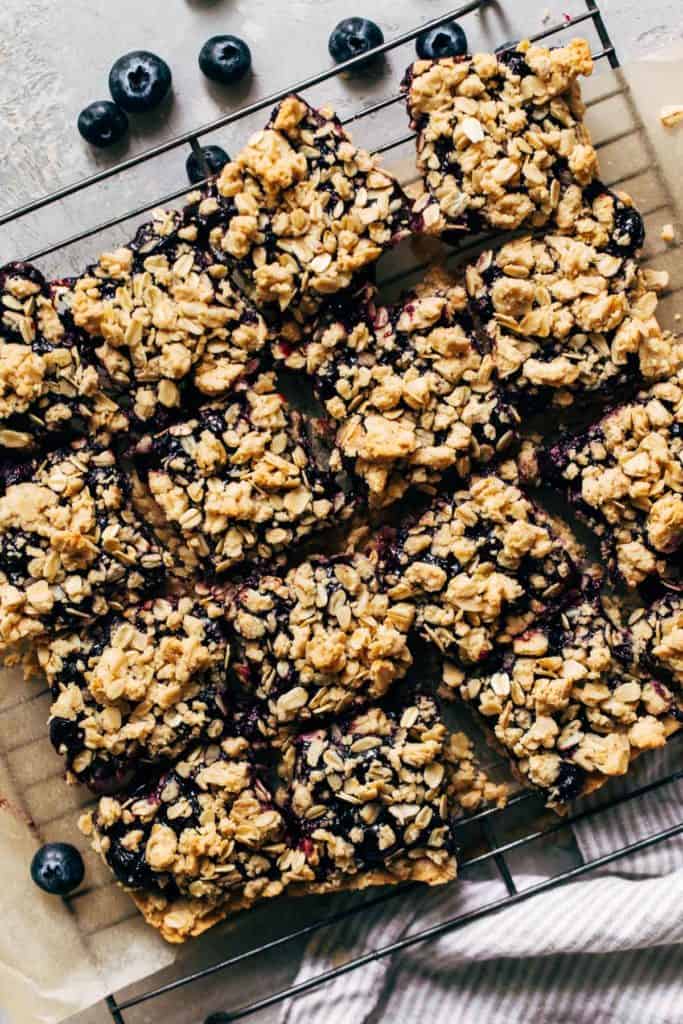 a cooling rack full of sliced blueberry crumble bars