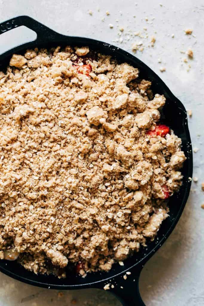 crumble topping sprinkled on top of fresh strawberries and rhubarb