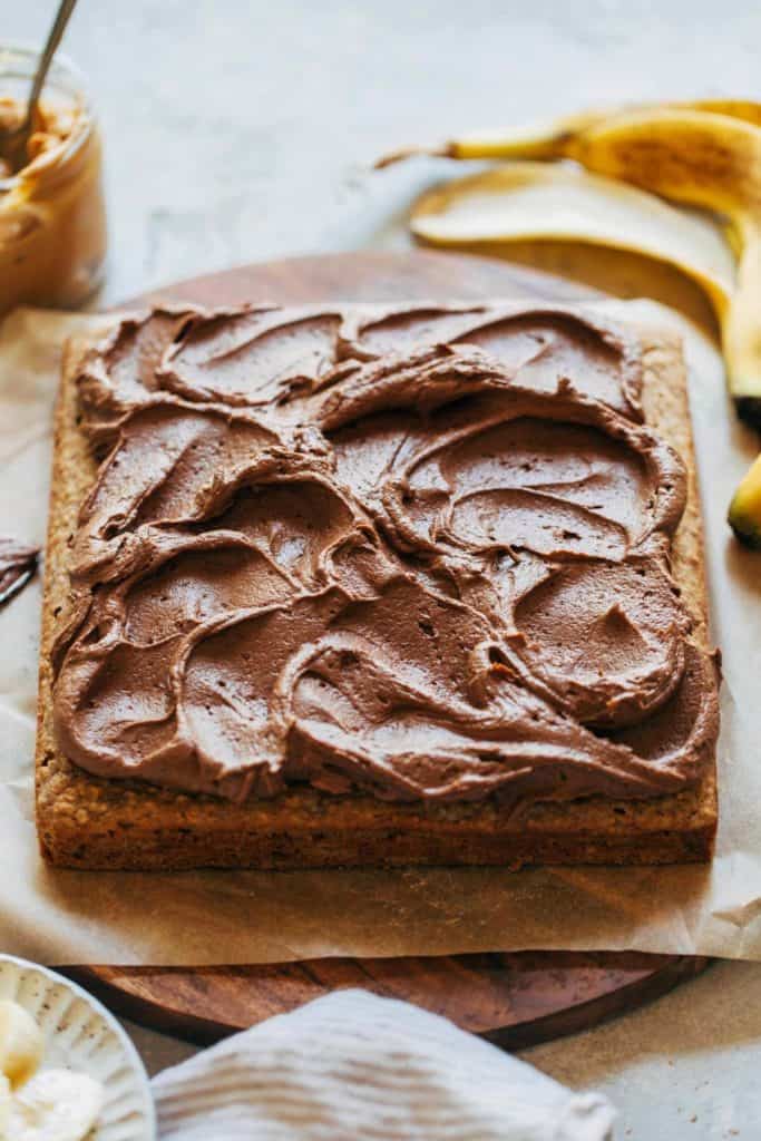 peanut butter chocolate frosting swirled on top of a sheet cake