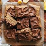 sliced banana sheet cake on a round cutting board