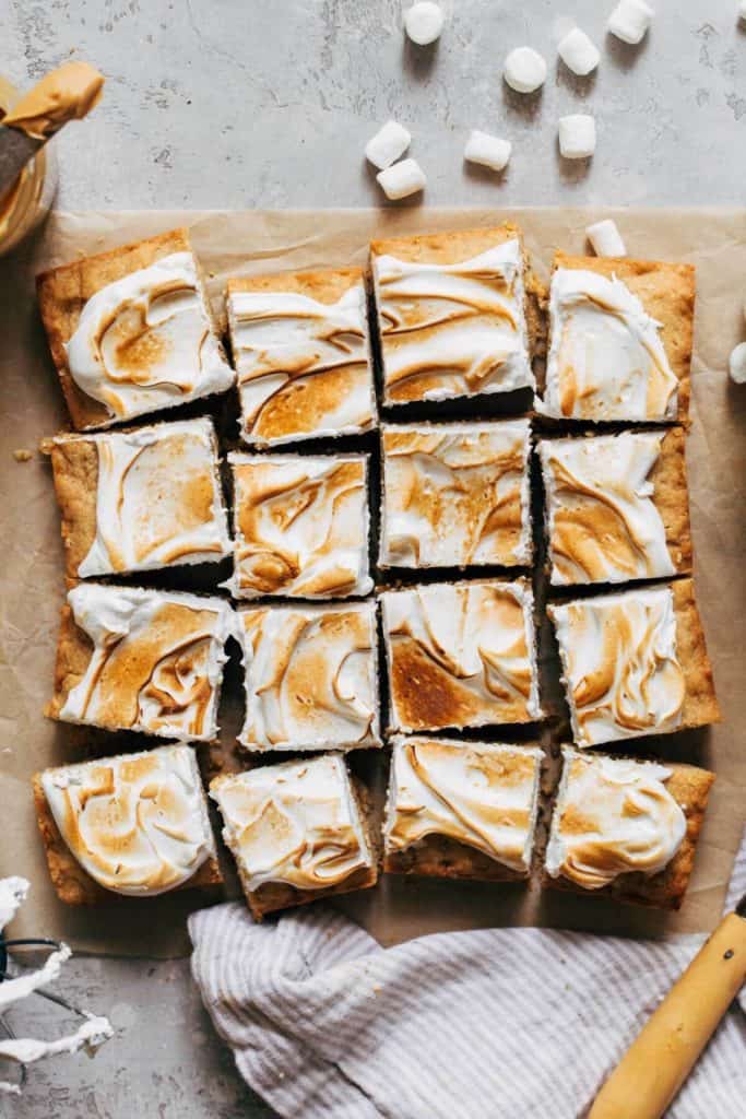 sliced peanut butter cookie bars topped with toasted marshmallow meringue