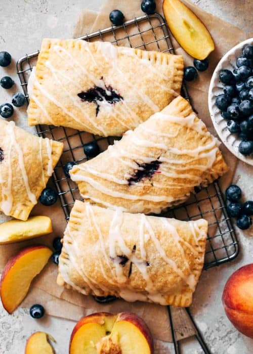 blueberry hand pies scattered on a cooling rack