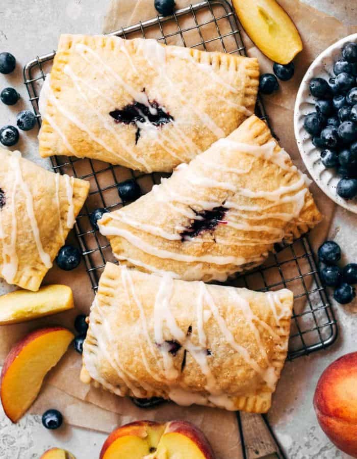 blueberry hand pies scattered on a cooling rack