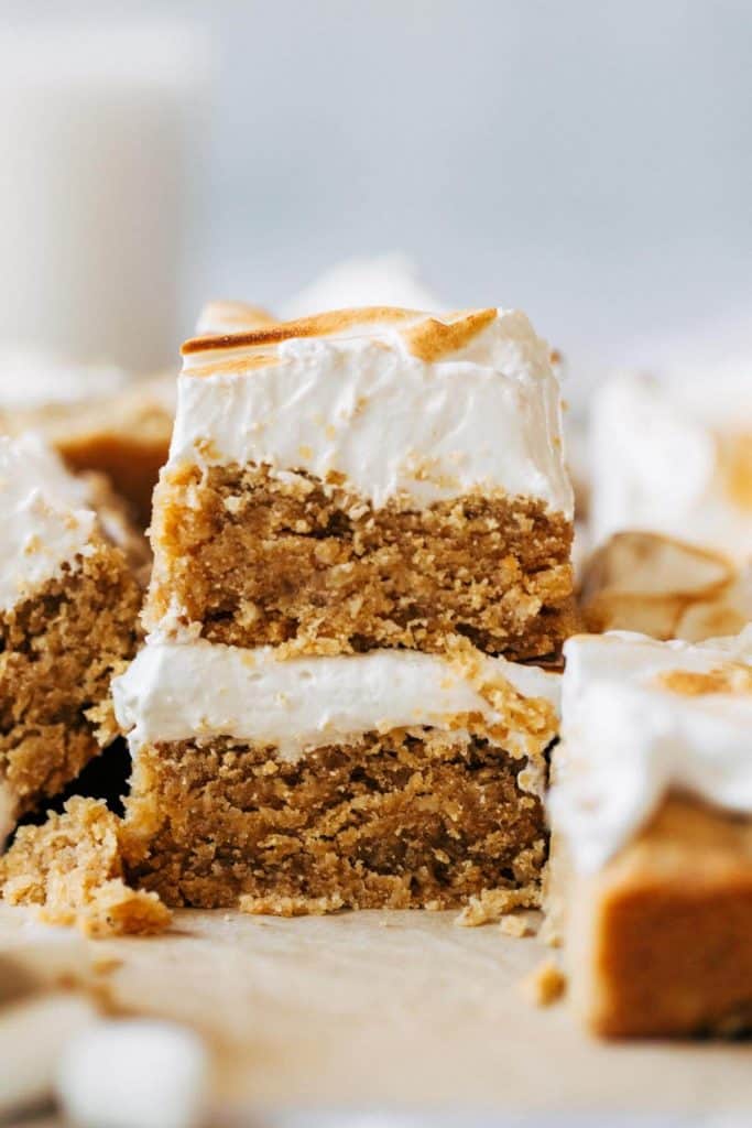 a stack of two peanut butter cookie bars topped with marshmallow meringue