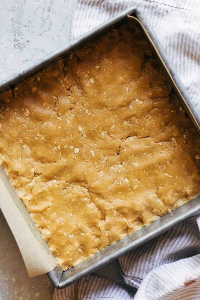 peanut butter cookie dough pressed into a square baking dish