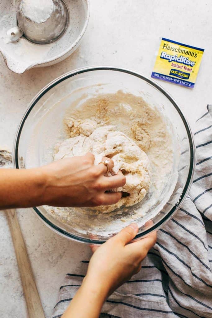 kneading dough in a bowl
