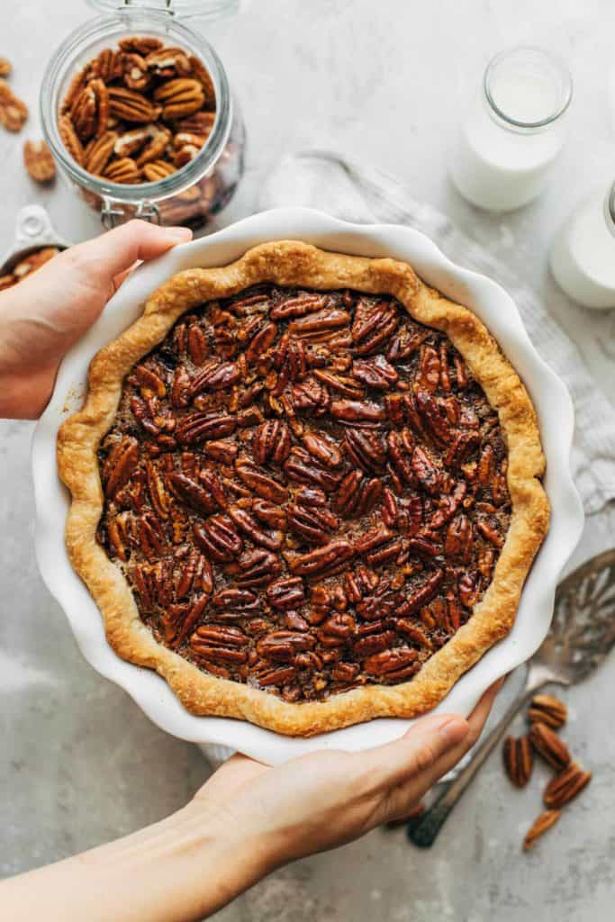 holding a freshly baked pecan pie