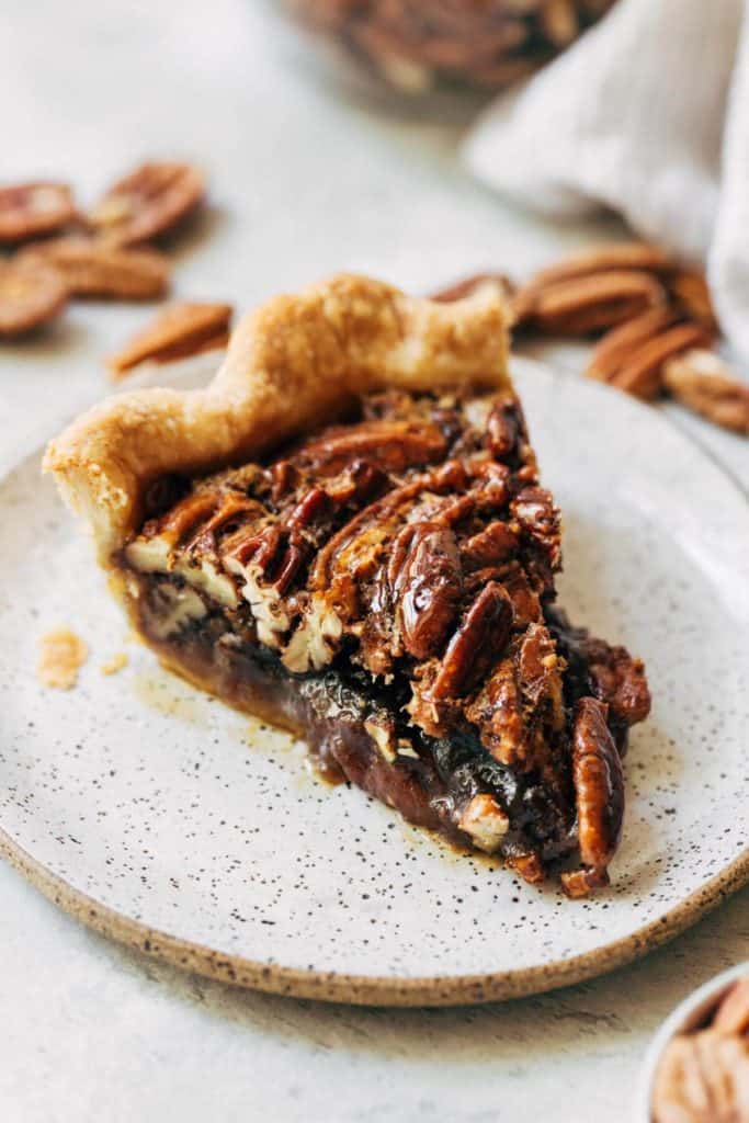 close up of a pecan pie slice on a plate